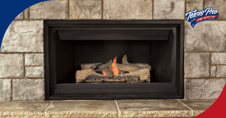 Close-up of a lit gas fireplace with glowing logs inside a stone-clad fireplace.