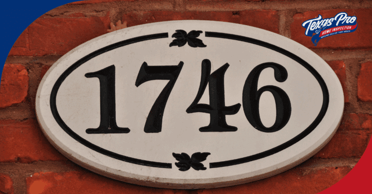 Oval white plaque with house number 1746 on a brick wall