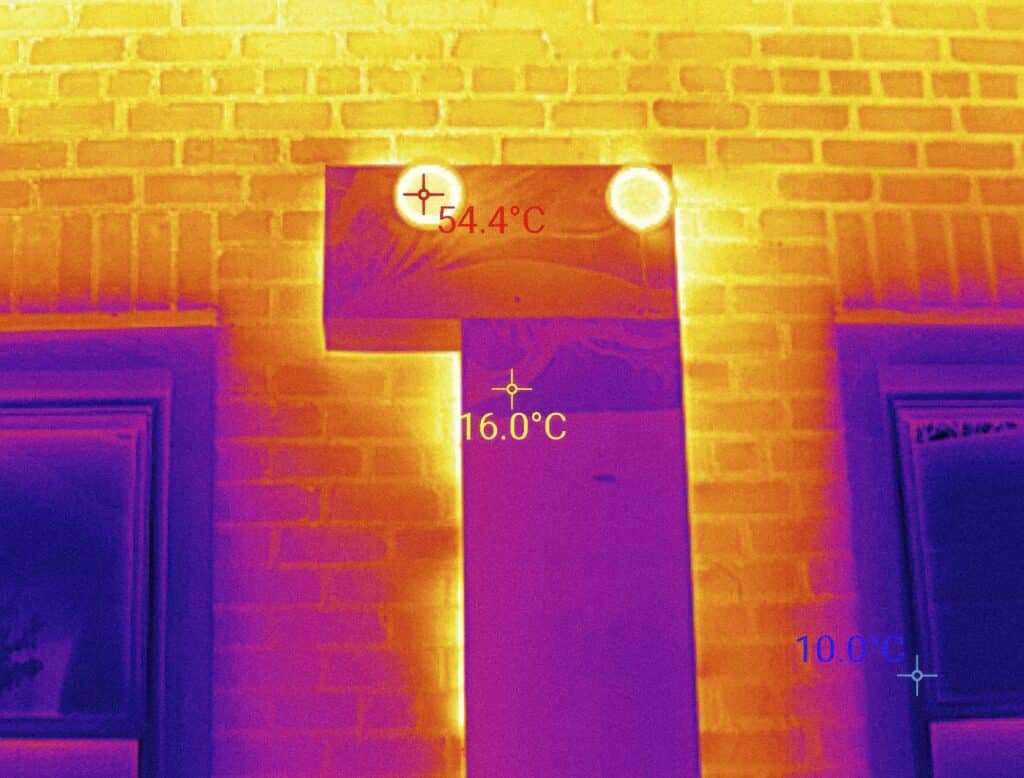 Thermal infrared image of brick home exterior showing temperature differentials around windows and door during a home inspection in Fort Worth, TX